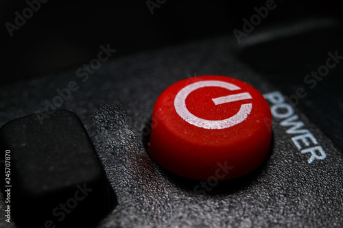 Red power key with black background. Macro close-up photography