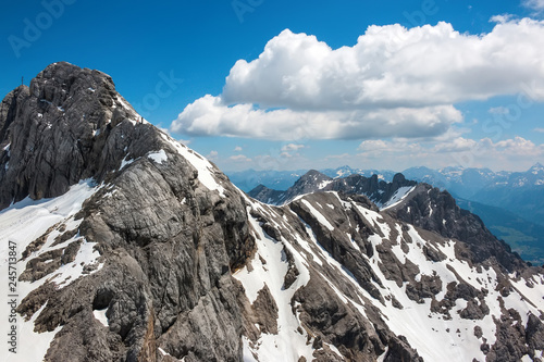 On peak of Dachstein and view alpine mountains