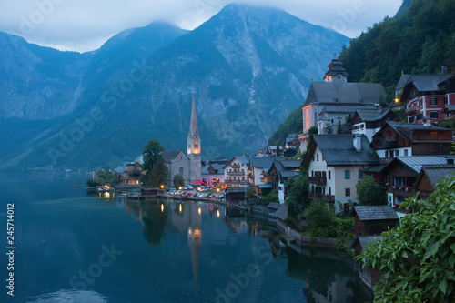 View of Hallstatt village with lake. Far away beauty Alpine rocks and blue sky