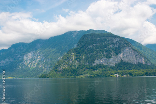 View idyllic Alpine mountains and lake in Hallstatt