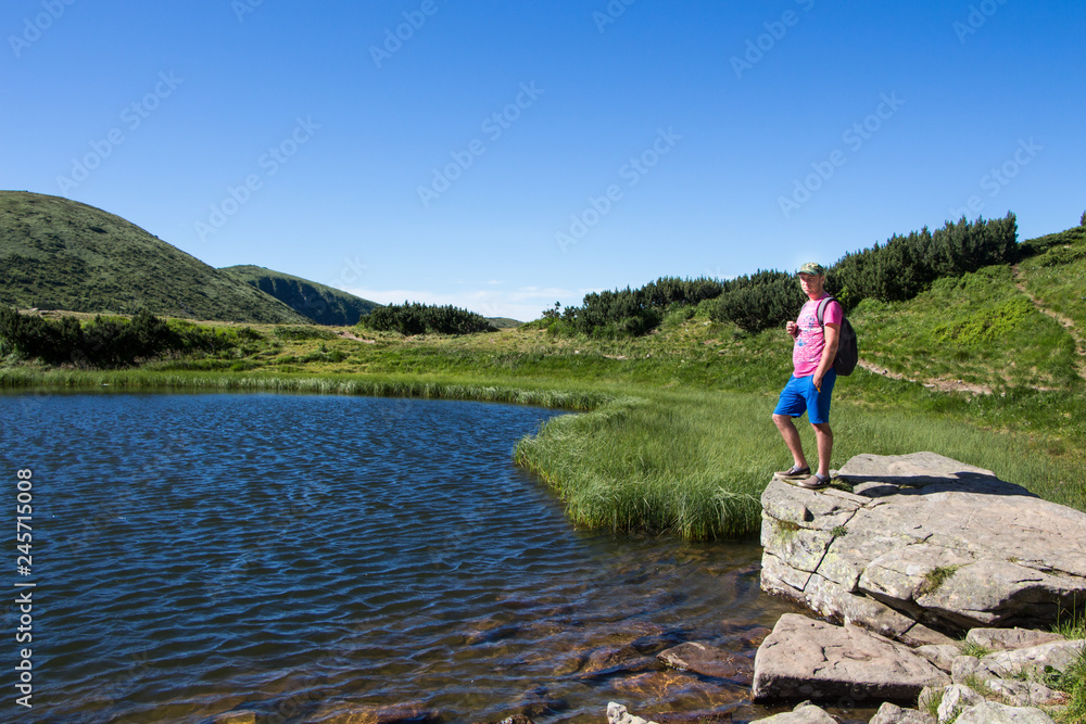 Young man hiking in the mountains