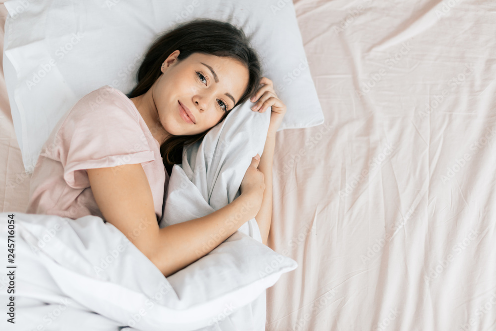 amorous girl before sleeping. top view photo. copy space. happiness amorous girl before sleeping. top view photo. copy space. happiness