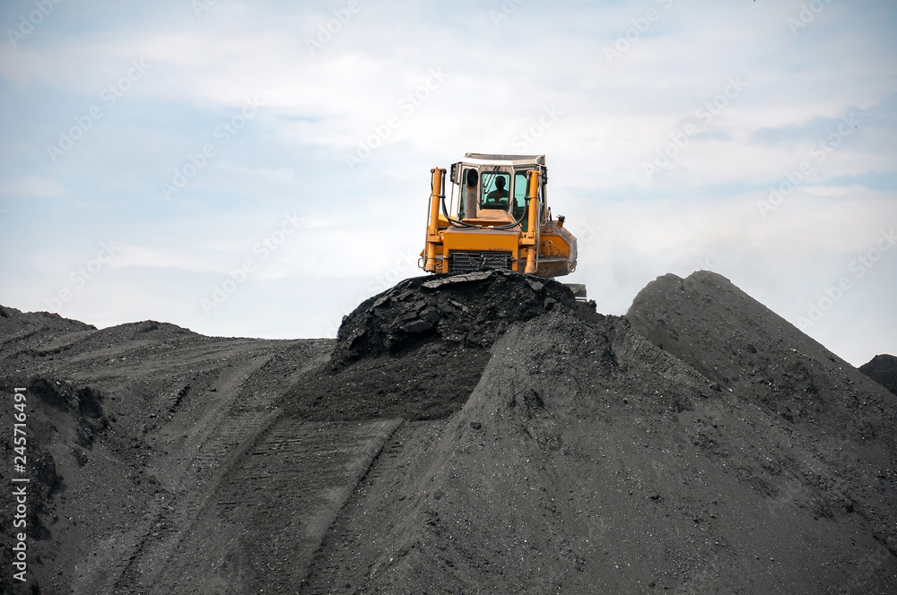 caterpillar tractor and travelling crane load black coal on supply field of thermoelectric power station caterpillar tractor and travelling crane load black coal on supply field of thermoelectric power station