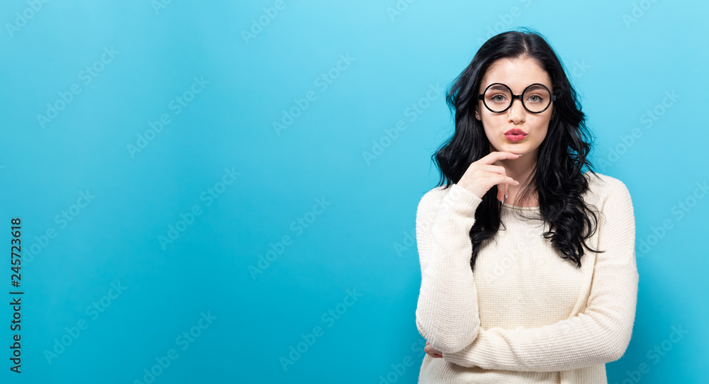 Young woman in a thoughtful pose on a solid background Young woman in a thoughtful pose on a solid background