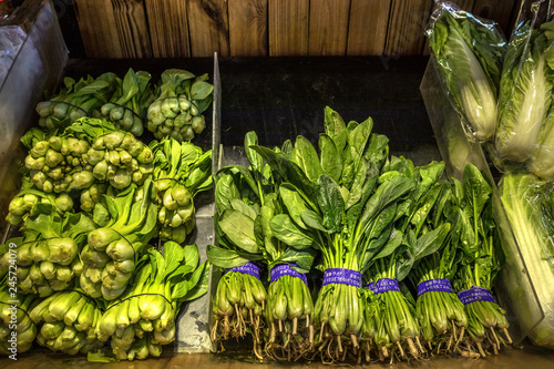 Natural Vegetables on Market Counter. Bok Choy, Chinese White Cabbage (left) and Spinach (right)