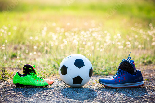 football and soccer shoes with blurry of green grass for soccer player training © Koonsiri