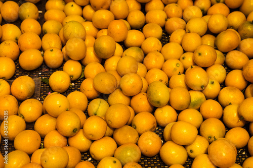 Natural Vegetables on Market Counter. Chinese tiny orange, Calamondin photo