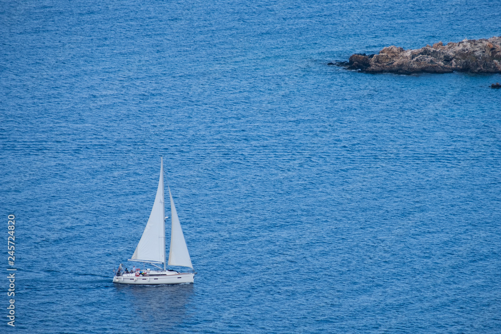 Sailing boat seen from Aphrodite trail, Akamas peninsula, Cyprus