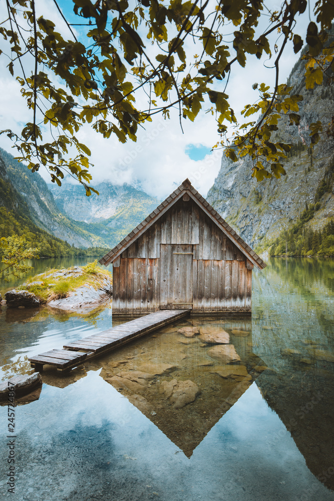 Wooden boat house at Lake Obersee on a beautiful sunny day with blue sky and clouds in summer, Nationalpark Berchtesgadener Land, Bavaria, Germany