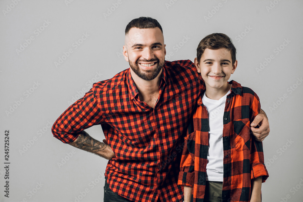 cheerful daddy and son in stylish outfits. close up portrait. friendship. closeness cheerful daddy and son in stylish outfits. close up portrait. friendship. closeness