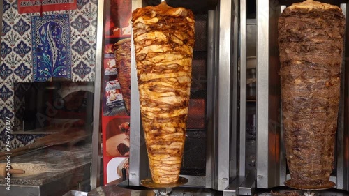 Cooking shawarma. Big shawarma skewers spin in the kitchen. HD video