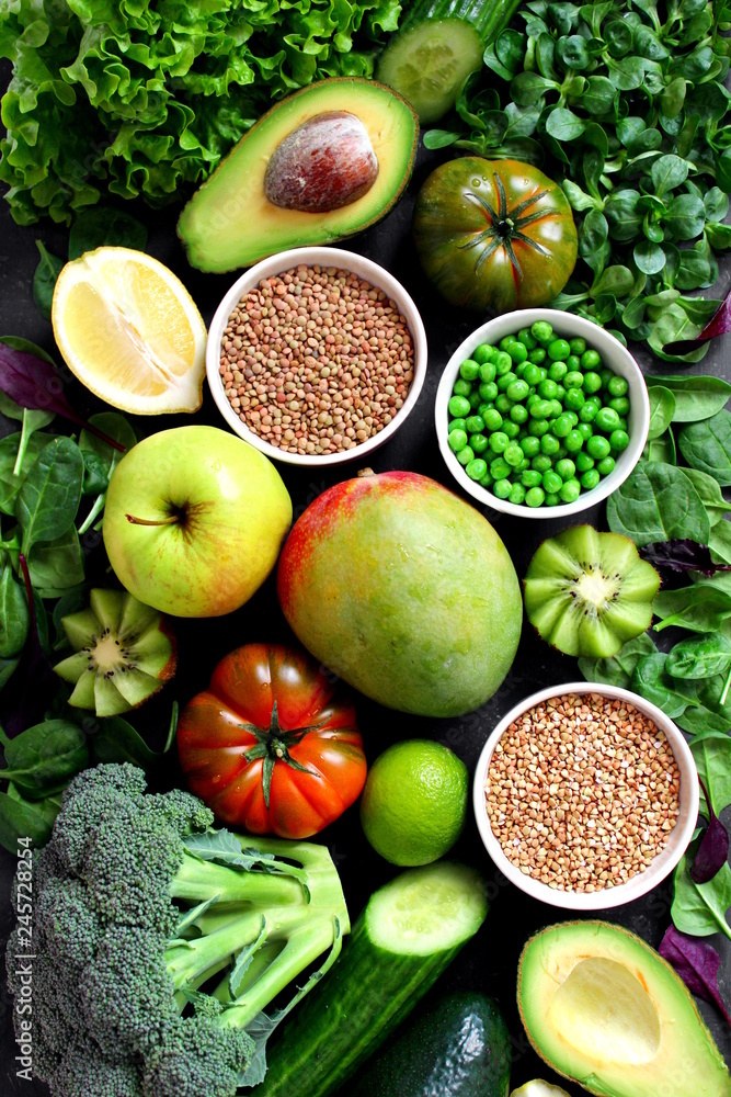 Clean eating selection Protein source for vegetarian: avocado, apple, broccoli, spinach, green peans on dark background. Healthy green food. Top view with copy space. Diet food. Clean eating selection Protein source for vegetarian: avocado, apple, broccoli, spinach, green peans on dark background. Healthy green food. Top view with copy space. Diet food.