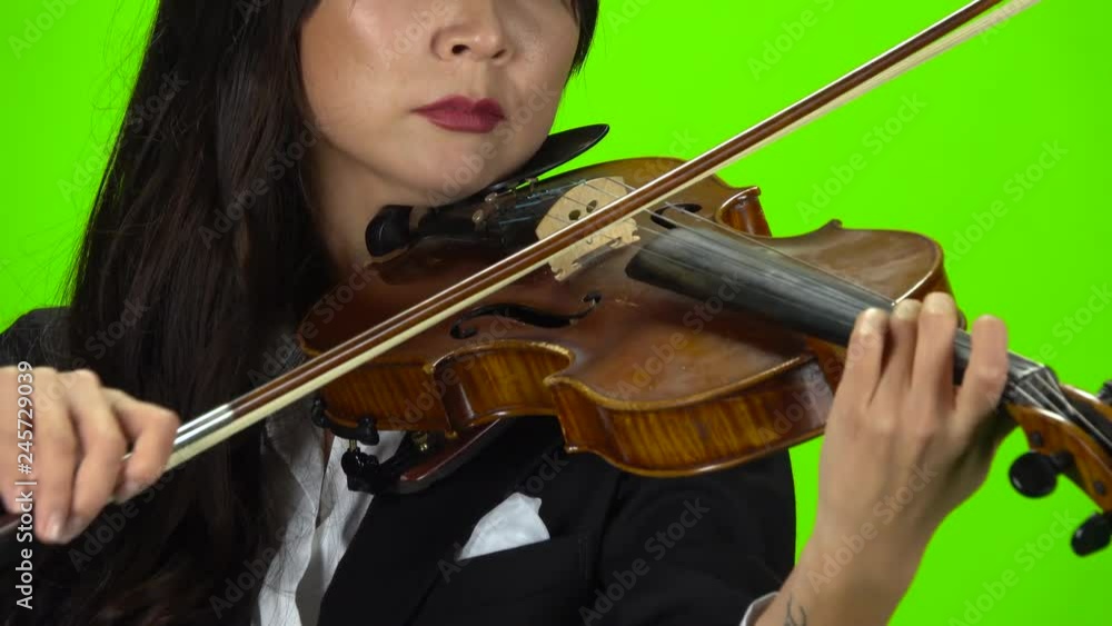 Woman fingering the strings playing violin. Close up. Green screen Woman fingering the strings playing violin. Close up. Green screen