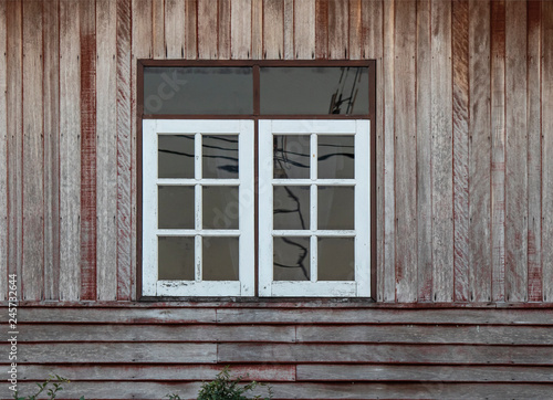 White color windows and old brown color wooden wall.