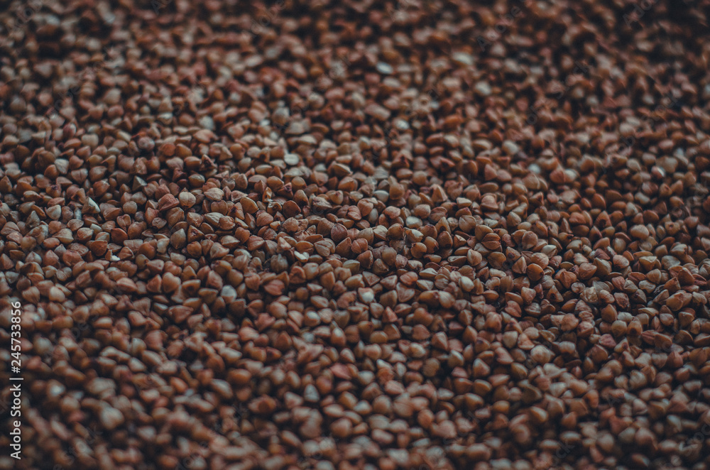 Buckwheat dark toned rough grain textured background Buckwheat dark toned rough grain textured background