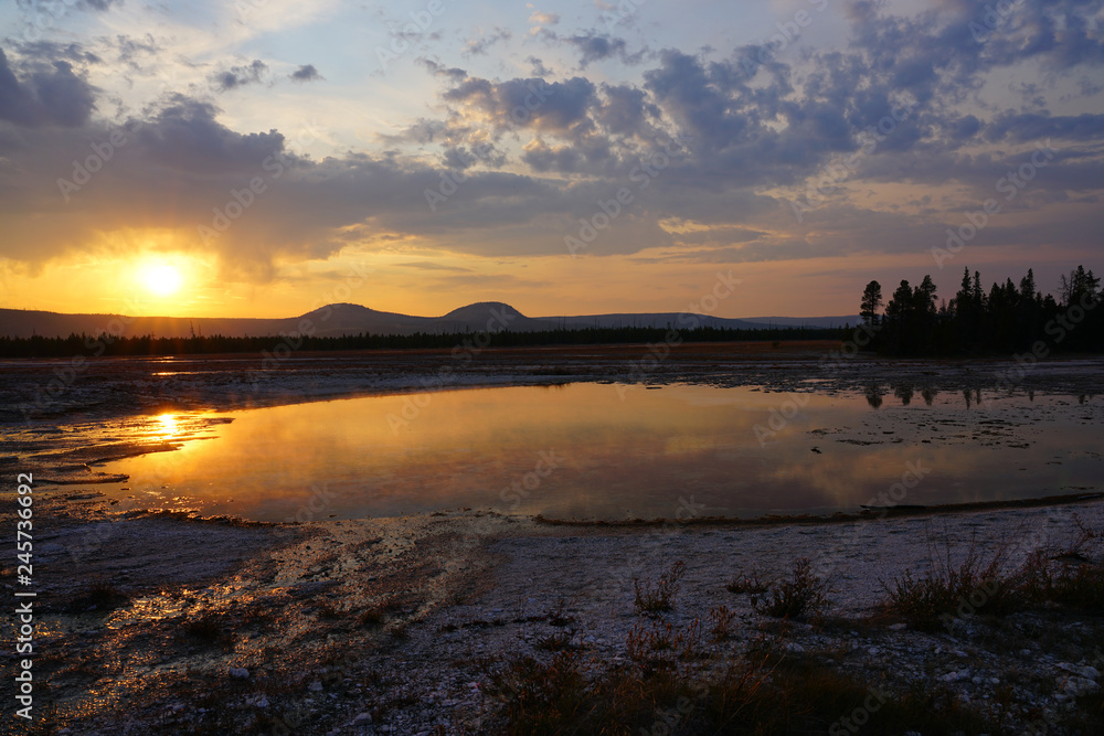 Sunset fumes over the Grand Prismatic pool in Yellowstone National Park, United States Sunset fumes over the Grand Prismatic pool in Yellowstone National Park, United States