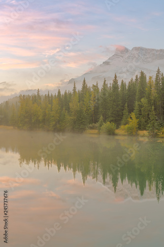 Fototapeta Naklejka Na Ścianę i Meble -  Morning mist on the Cascade Pond with beautiful water reflection at Banff National park