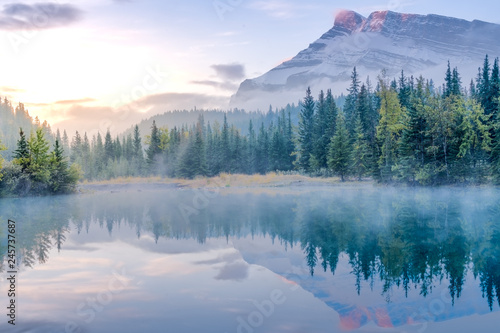 Golden yellow sky of morning sunrise with water refelction of Cascade pond in Banff National park photo