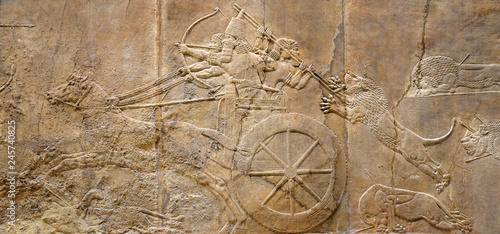 Assyrian relief of lions and warriors, ancient art of Mesopotamia. 