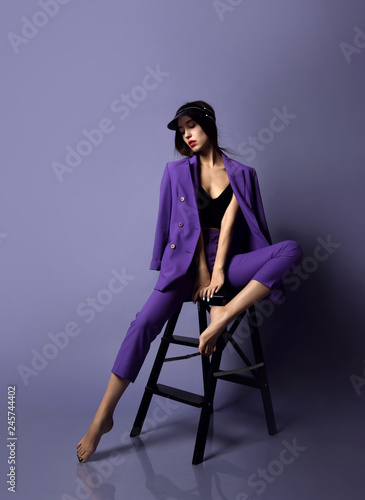 Beautiful hipster girl model posing in purple suit and underwear
