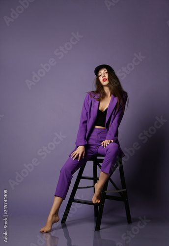 Beautiful hipster girl model posing in purple suit and underwear