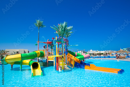 swimming pool with coconut tree and white umbrella