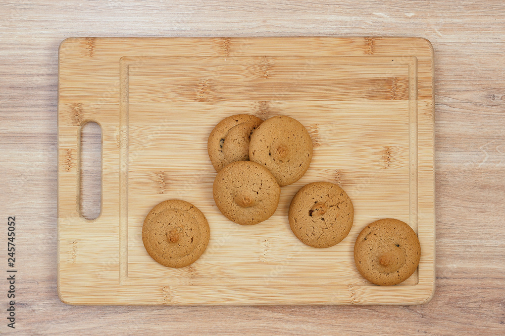 Homemade round cookies on a wooden board on a table, closeup Homemade round cookies on a wooden board on a table, closeup