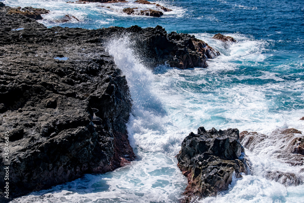 Atlantic ocean waves breaking over igneous rock on the edge of the lava field at Playa de Los Guirres, La Palma, Canary Islands, Spain Atlantic ocean waves breaking over igneous rock on the edge of the lava field at Playa de Los Guirres, La Palma, Canary Islands, Spain