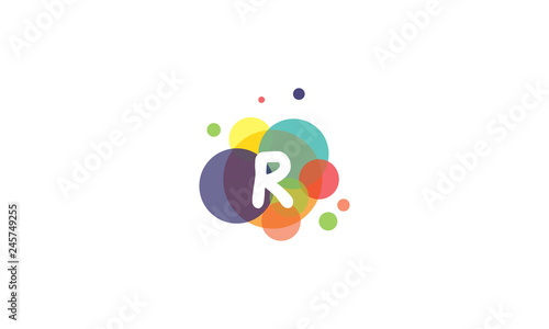 Bright and colorful image of the letter R, against the background of multicolored circles.