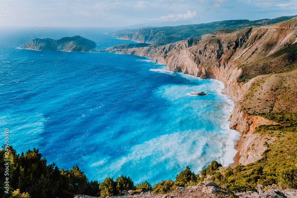 Fototapeta premium Amazing coastline landscape near Assos village. Sea waves rolling to shore cliffs on the beach. Kefalonia, Ionian islands, Greece