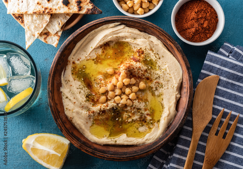 Classic Hummus with chickpeas, paprika, olive oil and oriental spices. Mediterranean popular snack of chickpeas and tahini pasta.