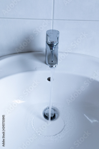 water flowing from faucet in the bathroom