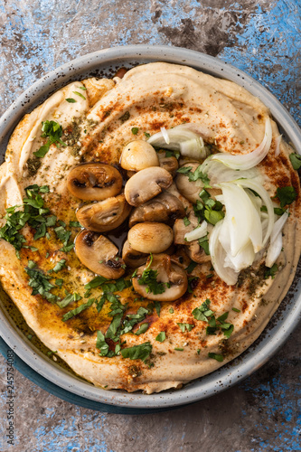 Traditional Mediterranean hummus with mushrooms and onions. Classic Hummus with paprika, olive oil, onions, mushrooms and seasonings