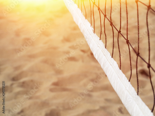Volleyball net on a tropical beach against the backdrop of sand. copy spase. sun leak.