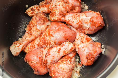 Marinated chicken legs in multicooker for frying.