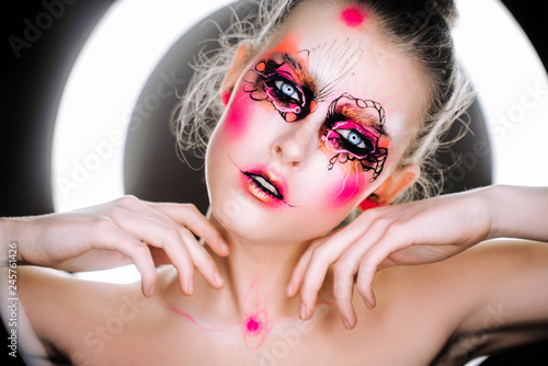  beautiful girl with art make-up clown photo