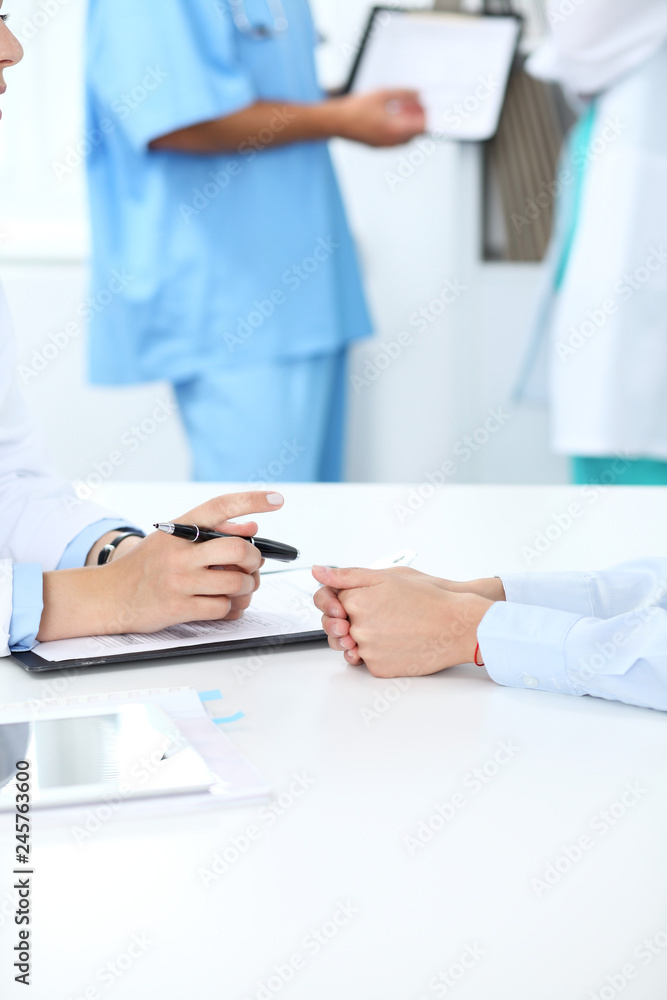 Doctor and patient discussing something, just hands at the table, white background Doctor and patient discussing something, just hands at the table, white background
