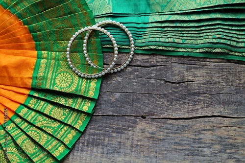 Indian decorations for dancing: bracelets, elements of the Indian classical costume for dancing bharatanatyam. Wooden background