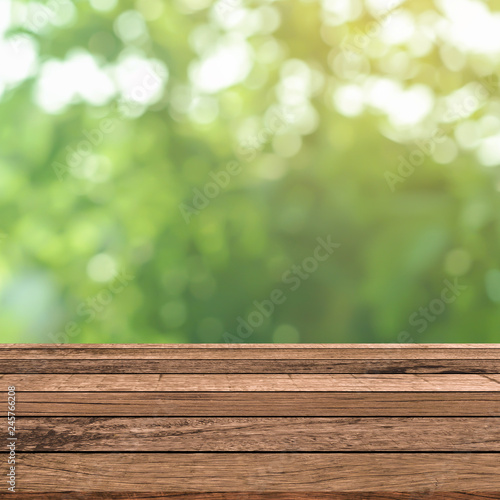 abstract blurred green nature with plank table for show,promote,ad product on image concept