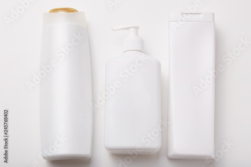Horiontal shot of plastic bottles with beauty products, empty space for your design. Body care products. Cosmetic concept. Shampoo, lotion, cream