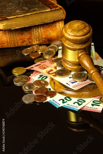 A bribe in court. Corruption in Justice. Judging hammer and euro banknotes. Judgment for money.