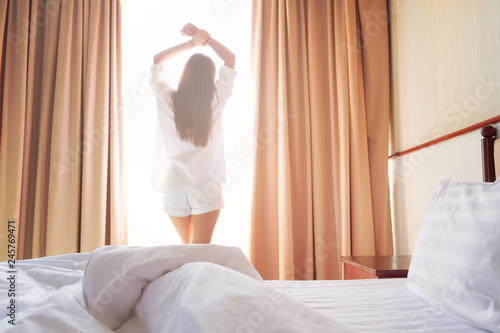 Woman stretching in bed after wake up.