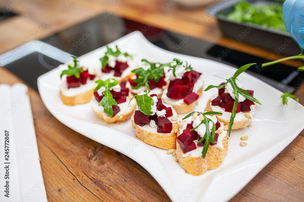 bruschetta with cheese and beetroot on a white plate