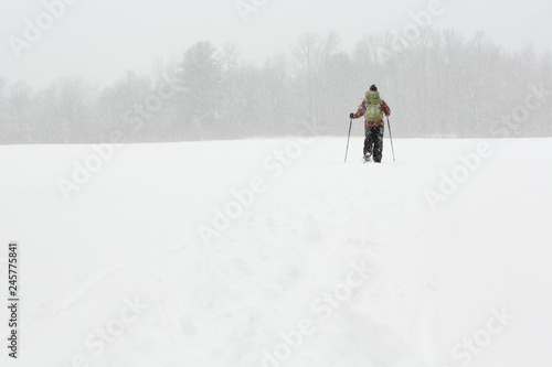 Adult Man Backpacking on Snowshoes in heavy Snow