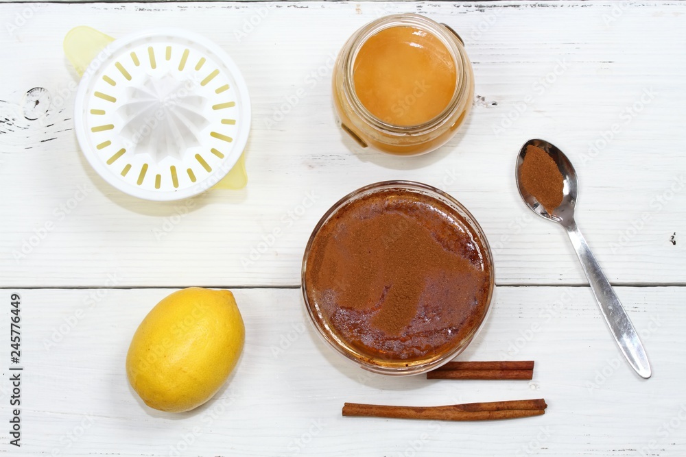 Cellulite treatment from honey, cinnamon and lemon. Ingredients for homemade anti cellulite wrap, flat lay Cellulite treatment from honey, cinnamon and lemon. Ingredients for homemade anti cellulite wrap, flat lay
