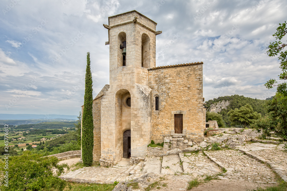 View of the Landscape of Luberon with the Church of Notre Dame Dalidon in the village Oppede le Vieux, Provence, Luberon, Vaucluse, France
