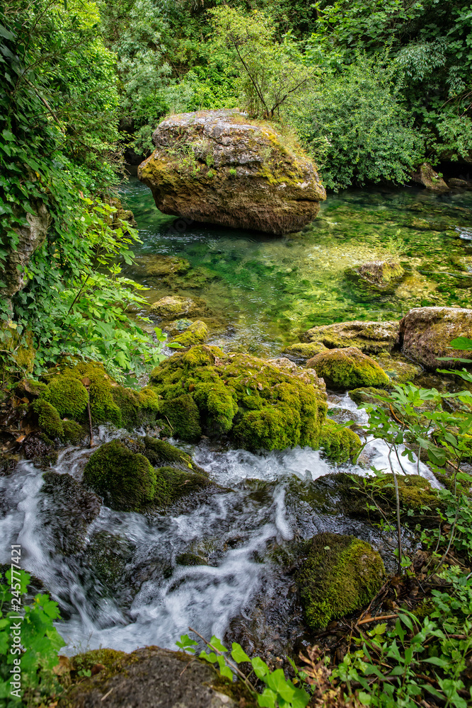 River landscape. River Sorgue with mossy rocks, Fontaine de Vaucluse, Provence, Luberon, Vaucluse, France River landscape. River Sorgue with mossy rocks, Fontaine de Vaucluse, Provence, Luberon, Vaucluse, France