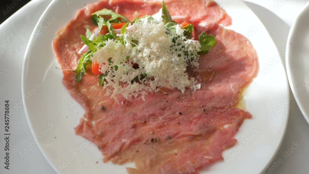 Beef carpaccio with arugula and parmesan cheese Beef carpaccio with arugula and parmesan cheese