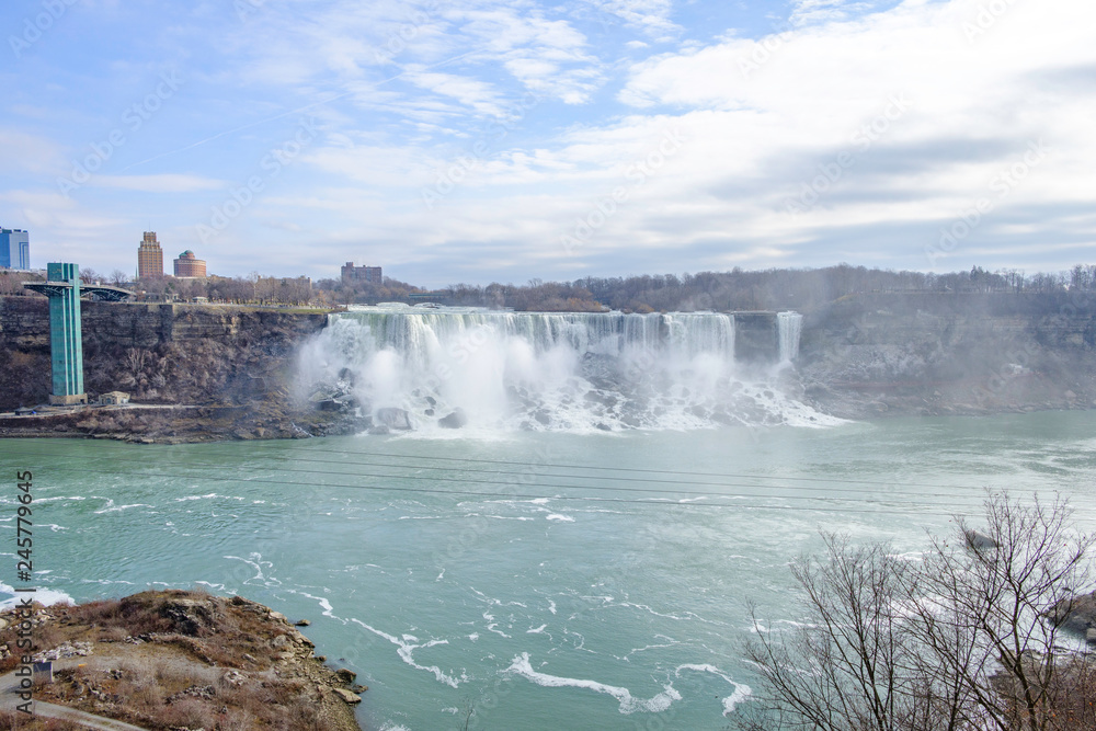 Scenic view of American falls and Bridal Veil Falls on Niagara river in Canada. Beautiful depressive winter look of two cascades of famous Niagara falls from Canadian side of border