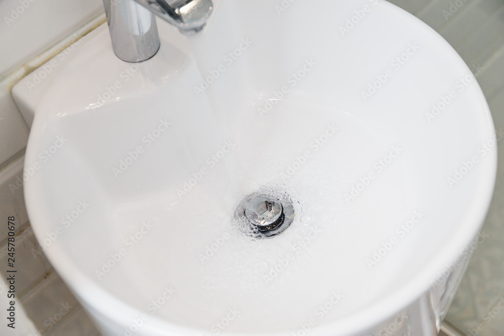 Drain chrome valve in white washbasin Drain chrome valve in white washbasin